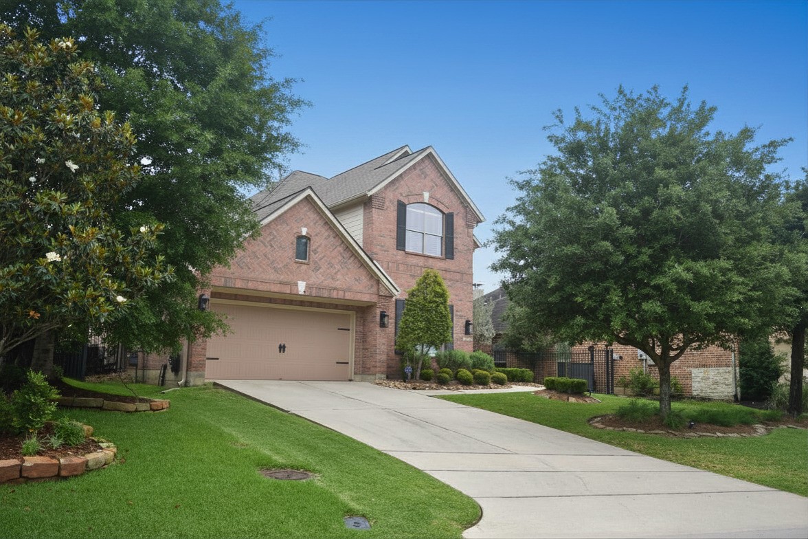 26 Winhall Place The Woodlands, TX 77354 - Photo 2 of 8 Beautiful brick elevation with mature landscaping and inviting curb appeal.