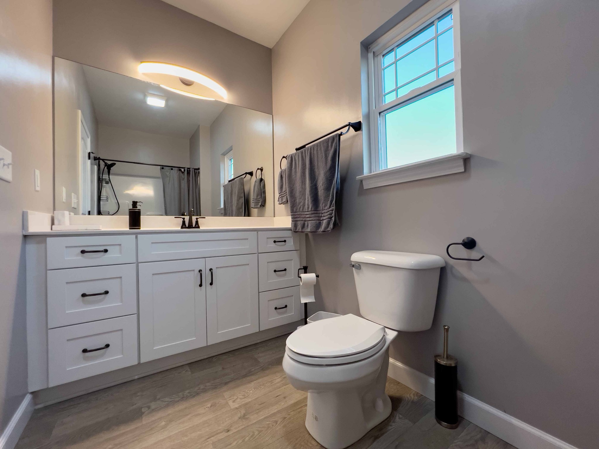 1239 Oak Grove Road Dickson, TN 37055 - Photo 31 of 54 a bathroom with a toilet sink a mirror a vanity and window