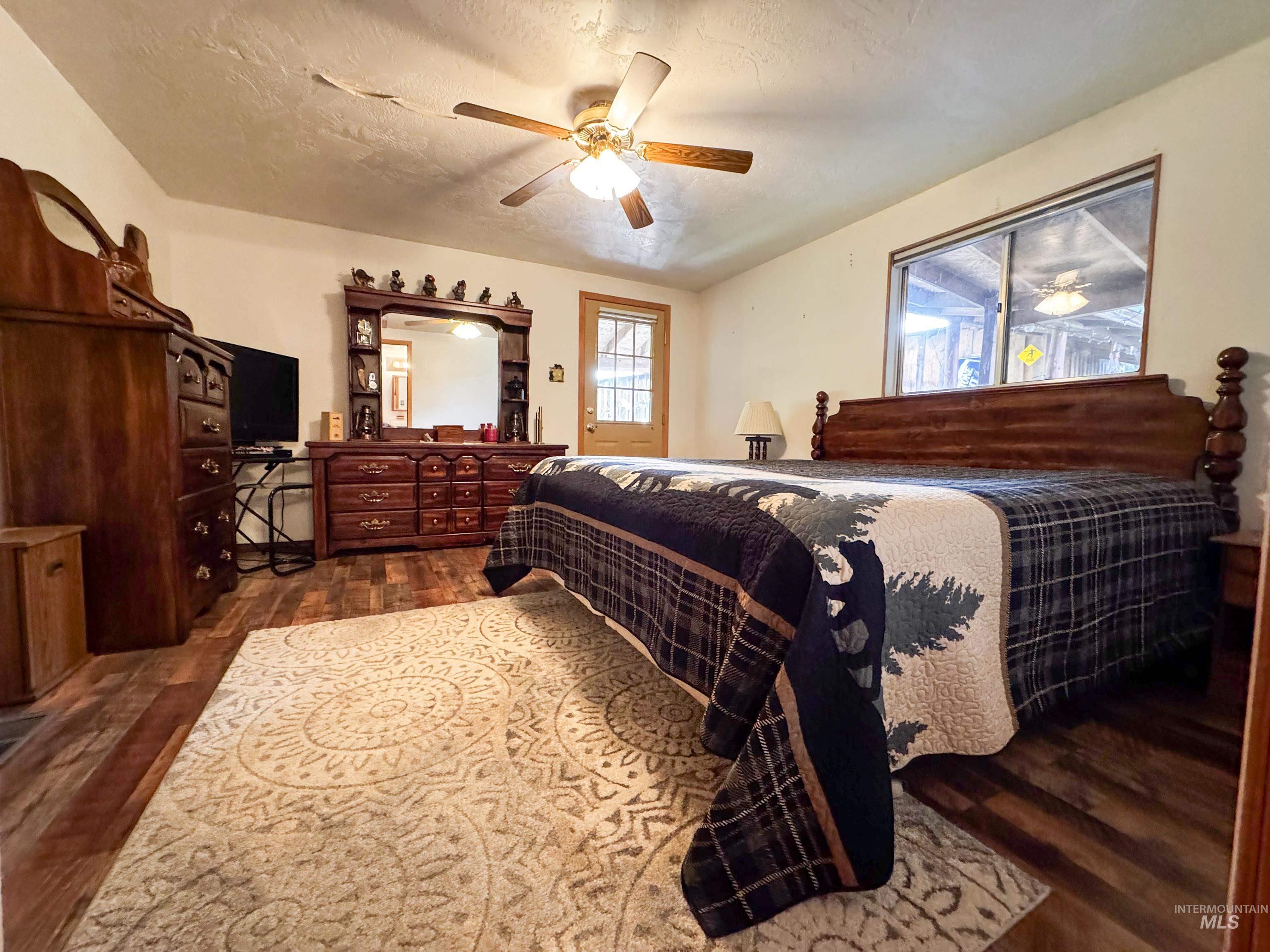 4482 Council Cuprum Road Council, ID 83612 - Photo 11 of 45 Bedroom with dark wood-type flooring, a textured ceiling, and ceiling fan