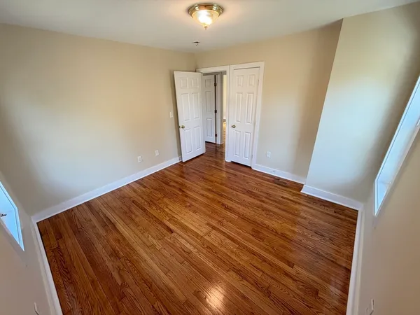 a view of room with wooden floor and fan