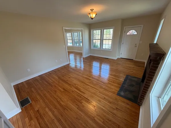 wooden floor in an empty room with a window