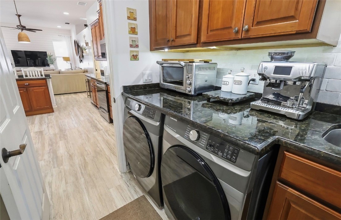 1771 Mistletoe Street Sebastian, FL 32958 - Photo 11 of 36 a kitchen with stainless steel appliances granite countertop a refrigerator a stove top oven a sink and dishwasher