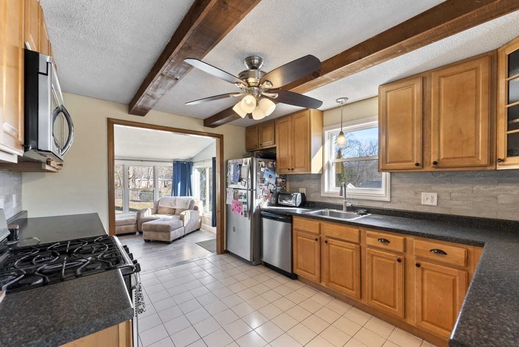 26 Exeter Street West Springfield, MA 01089 - Photo 11 of 42 a kitchen with stainless steel appliances granite countertop a stove and a sink