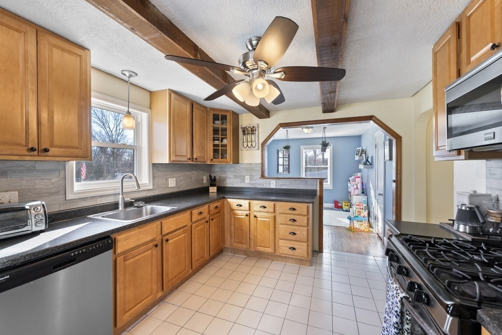 26 Exeter Street West Springfield, MA 01089 - Photo 12 of 42 a kitchen with stainless steel appliances a stove a sink and cabinets