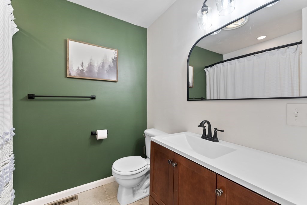 26 Exeter Street West Springfield, MA 01089 - Photo 30 of 42 a bathroom with a toilet sink and mirror