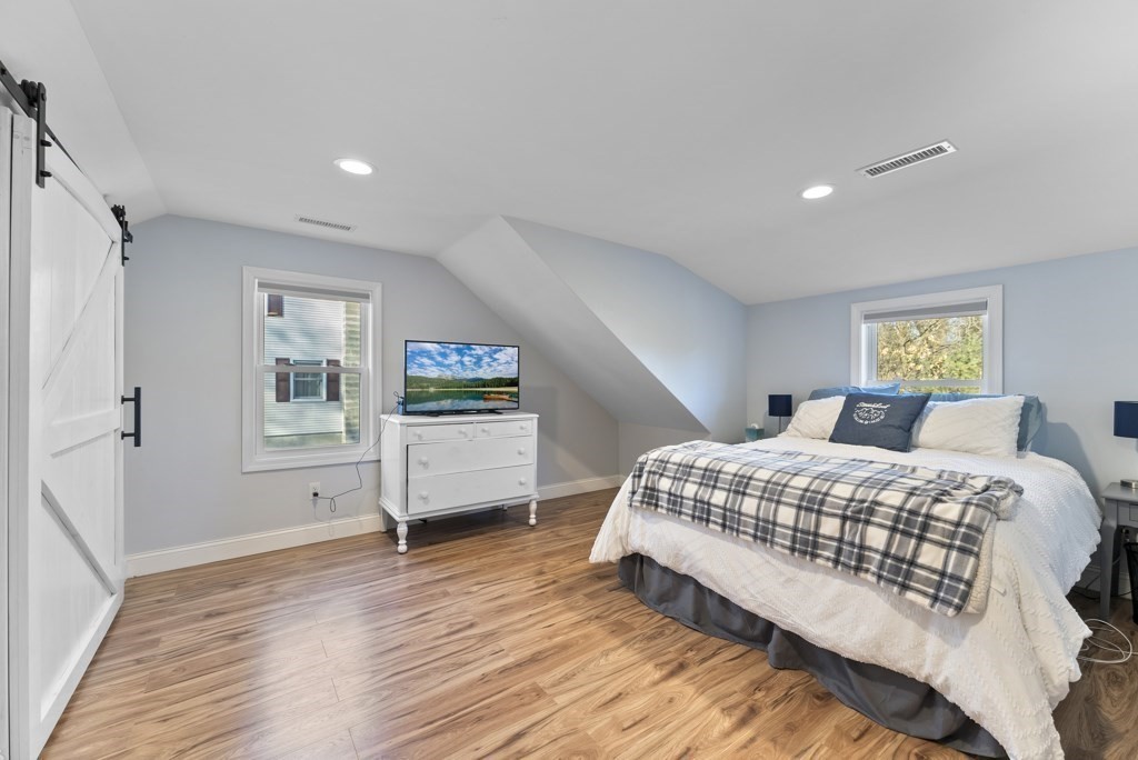 26 Exeter Street West Springfield, MA 01089 - Photo 32 of 42 a spacious bedroom with a bed wooden floor and window