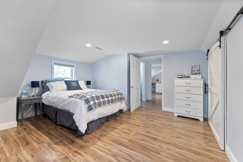 26 Exeter Street West Springfield, MA 01089 - Photo 33 of 42 a bedroom with a bed and wooden floor