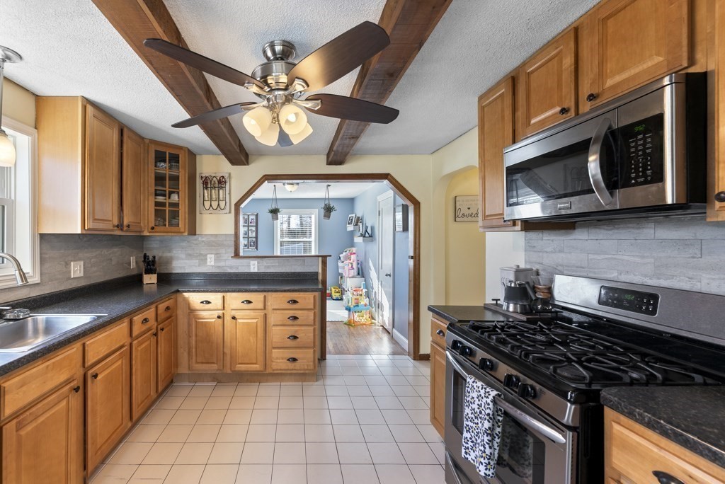 26 Exeter Street West Springfield, MA 01089 - Photo 10 of 42 a kitchen with stainless steel appliances granite countertop a stove and a sink