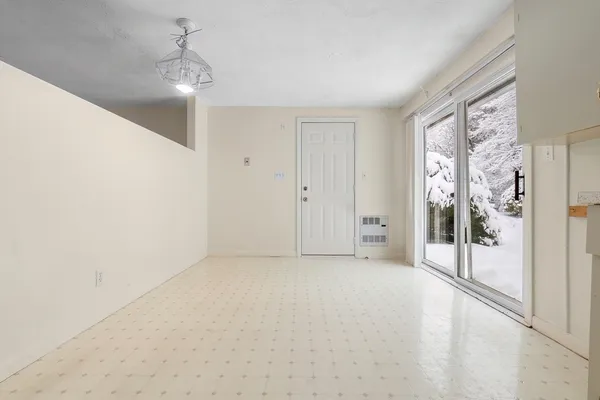 a view of an empty room with glass door