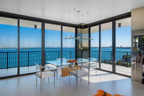 a view of a livingroom with furniture and floor to ceiling window