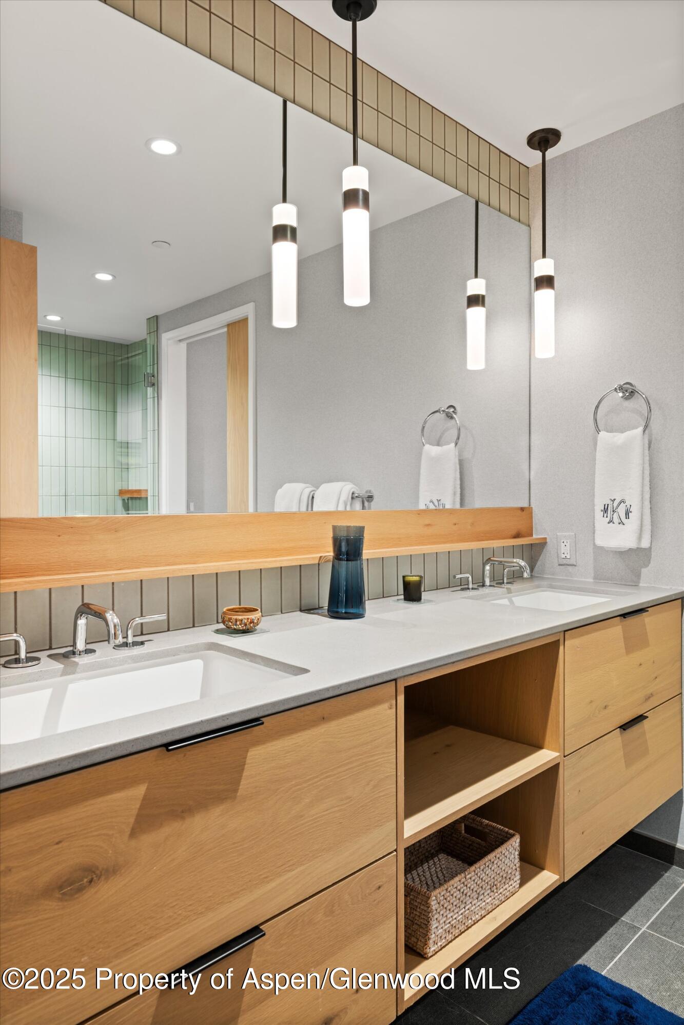 119 Wood Road, Unit 601 Snowmass Village, CO 81615 - Photo 13 of 20 a bathroom with a sink double vanity and a mirror