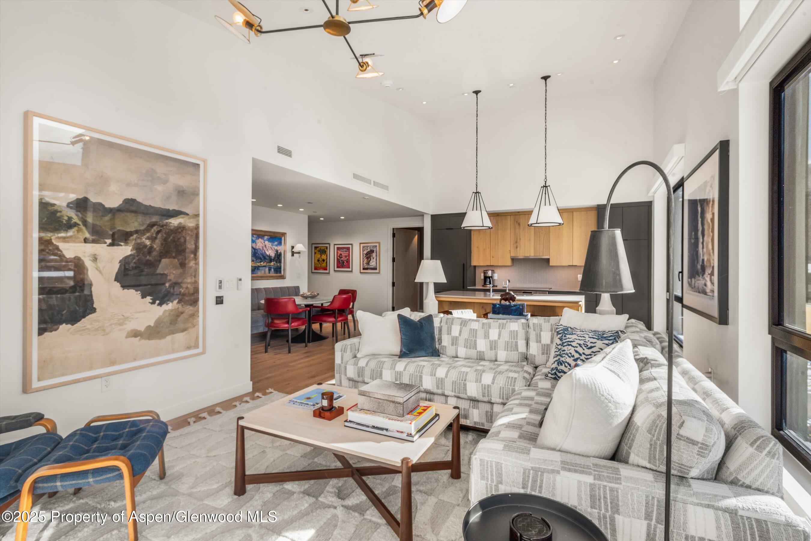 119 Wood Road, Unit 601 Snowmass Village, CO 81615 - Photo 3 of 20 a living room with furniture and a wooden floor