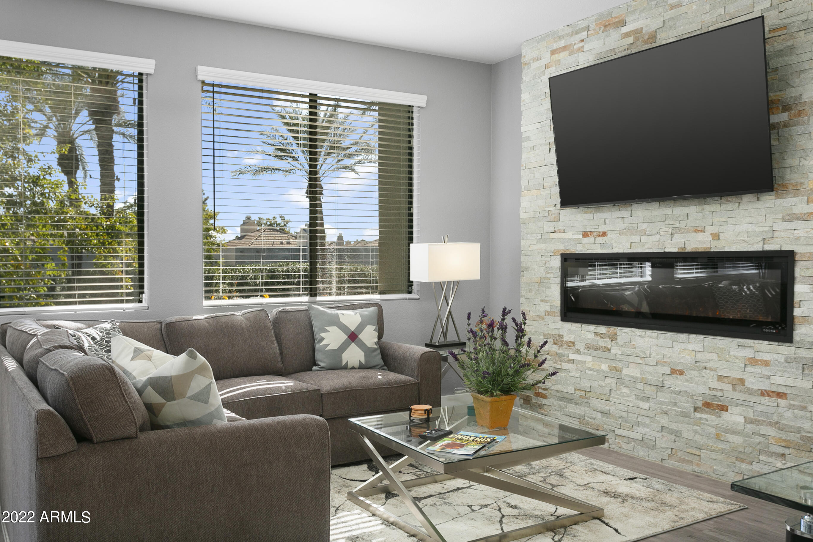 7700 East Gainey Ranch Road, Unit 206 Scottsdale, AZ 85258 - Photo 12 of 33 a living room with furniture and a flat screen tv