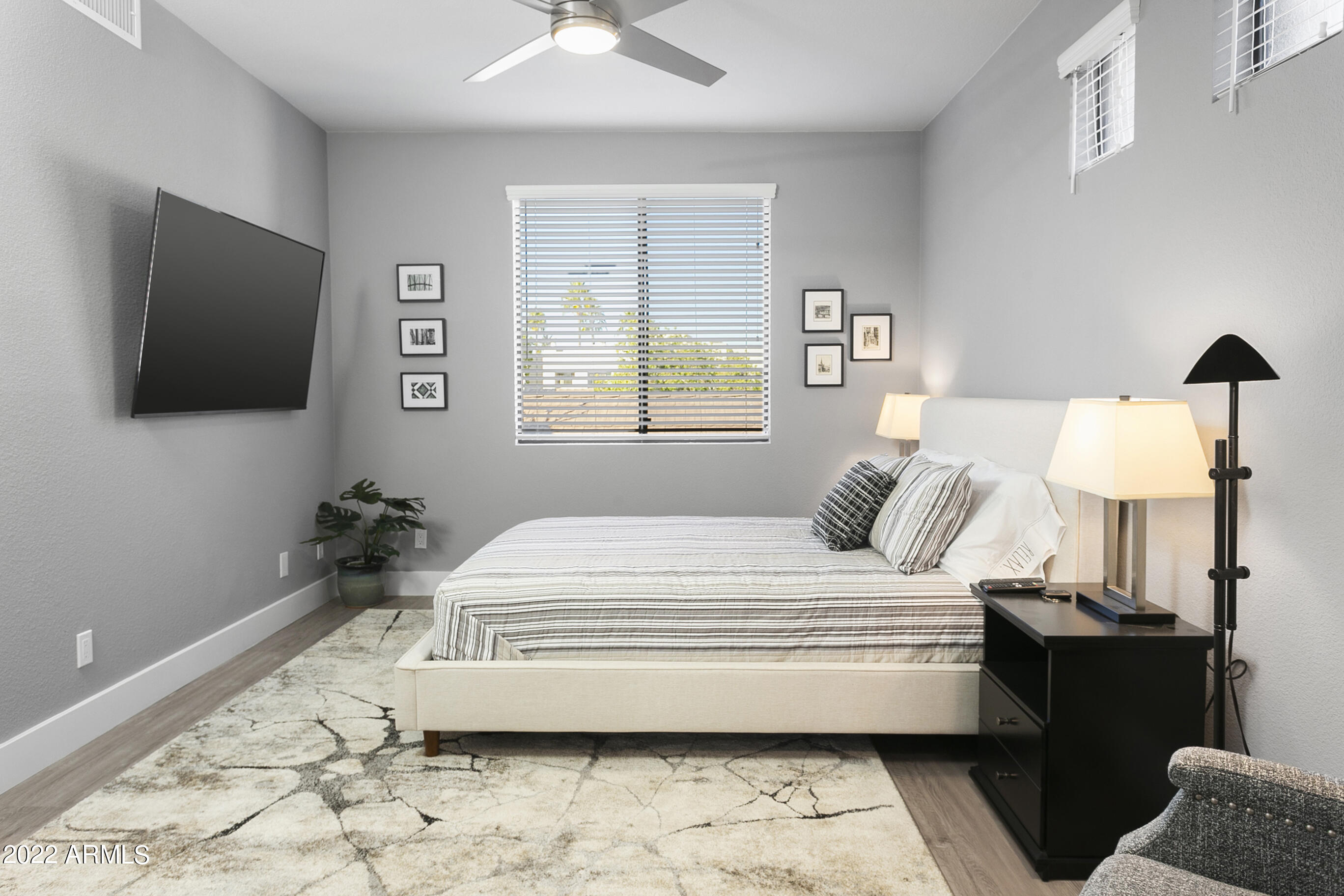 7700 East Gainey Ranch Road, Unit 206 Scottsdale, AZ 85258 - Photo 15 of 33 a bedroom with a bed and a flat screen tv