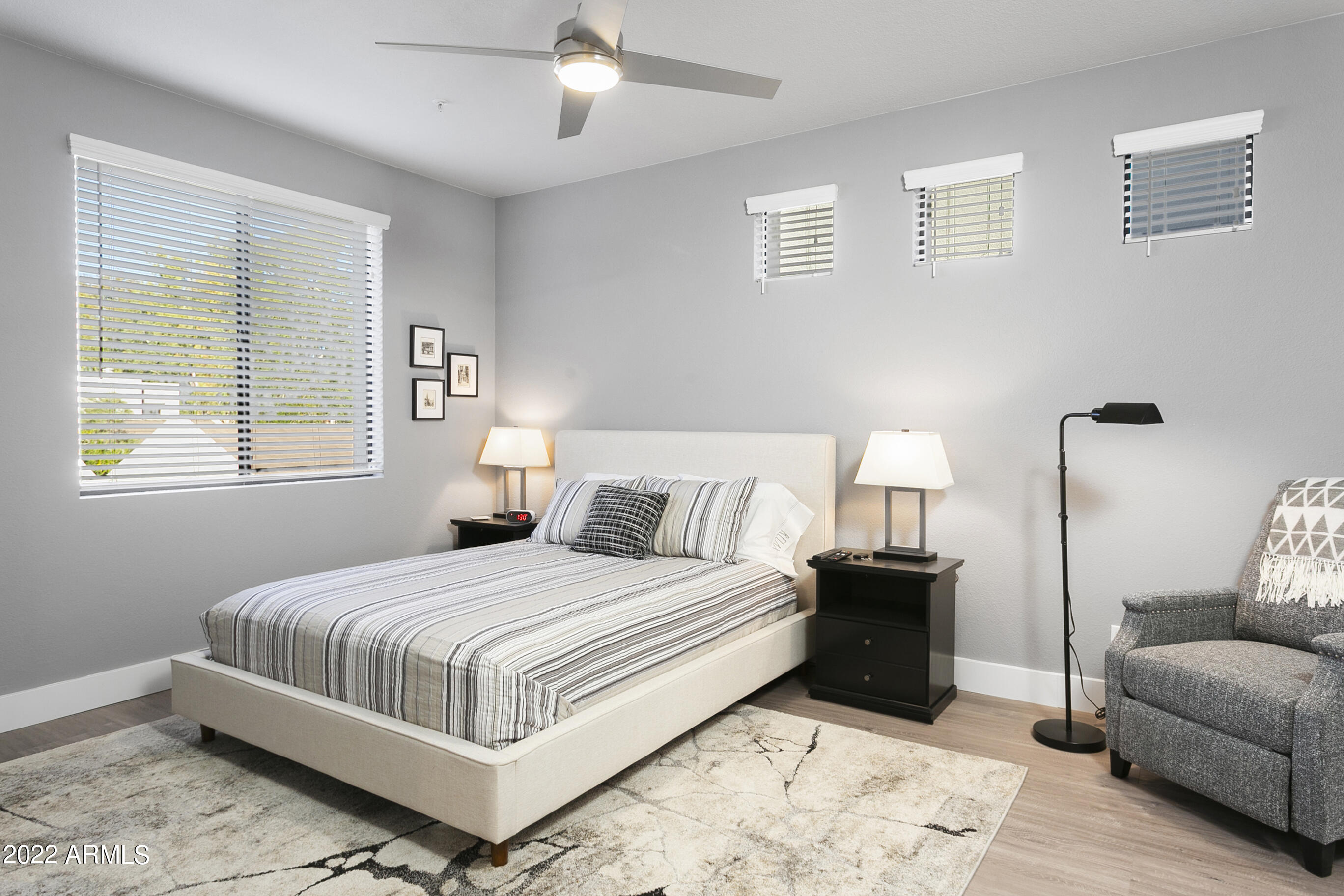 7700 East Gainey Ranch Road, Unit 206 Scottsdale, AZ 85258 - Photo 16 of 33 a bedroom with a bed and a couch