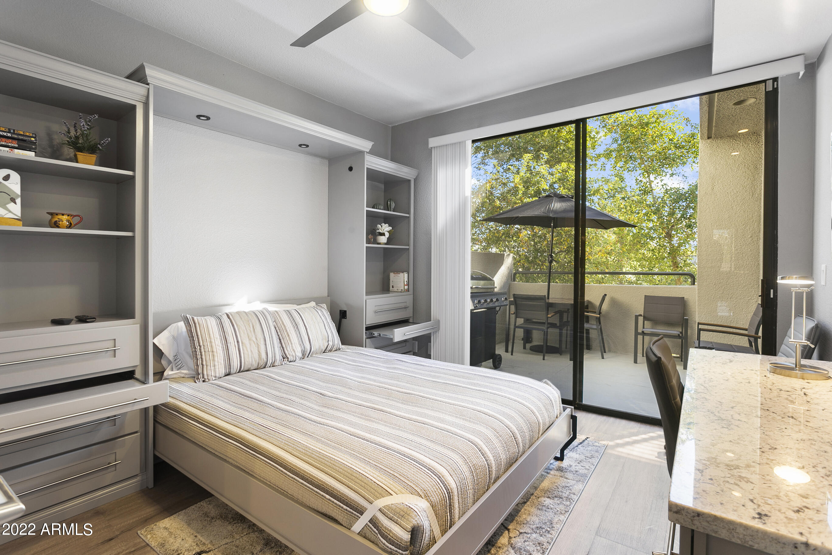 7700 East Gainey Ranch Road, Unit 206 Scottsdale, AZ 85258 - Photo 23 of 33 a bedroom with a bed and large window