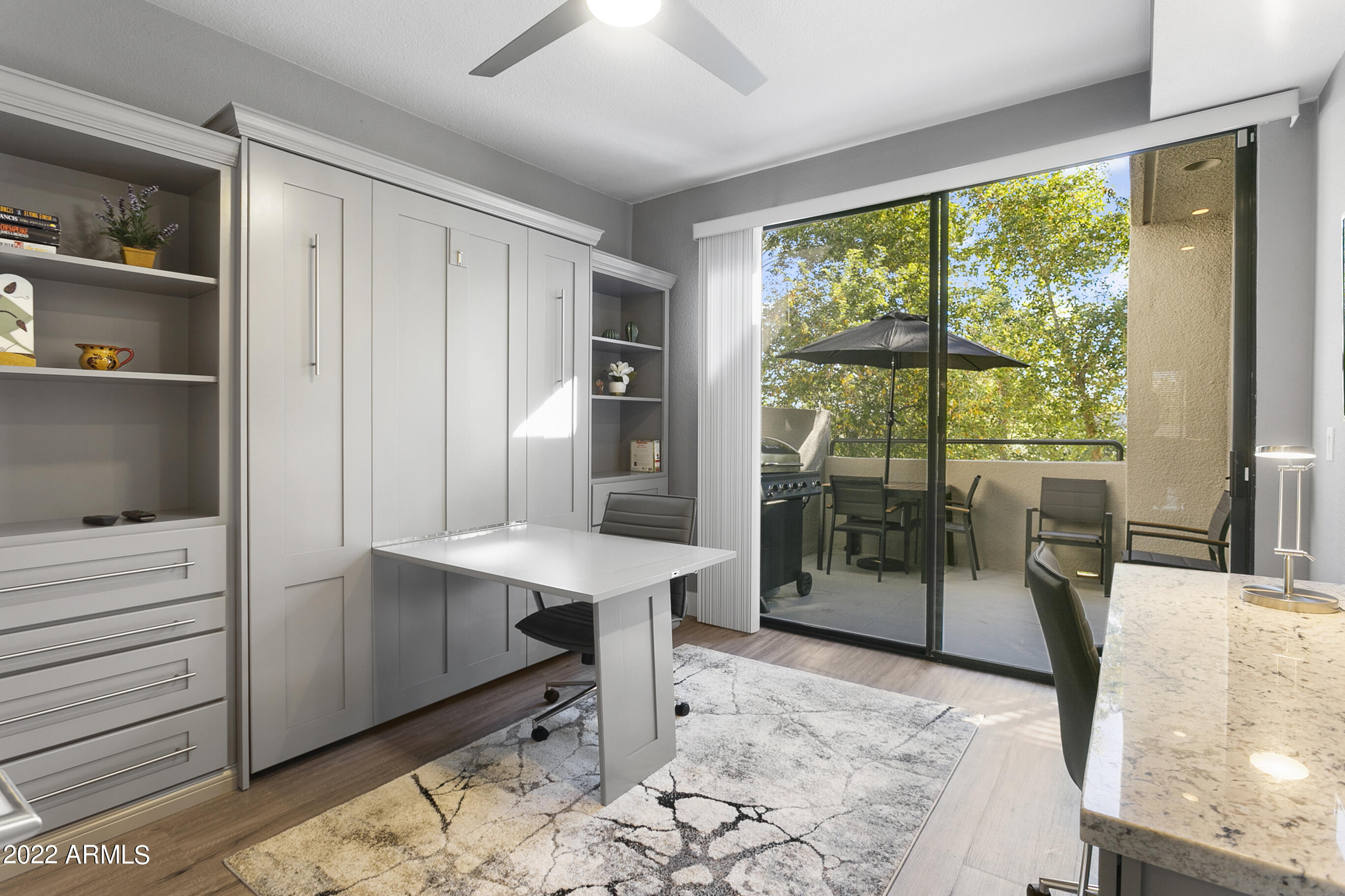 7700 East Gainey Ranch Road, Unit 206 Scottsdale, AZ 85258 - Photo 25 of 33 a bedroom with a bed and large window with the outer view