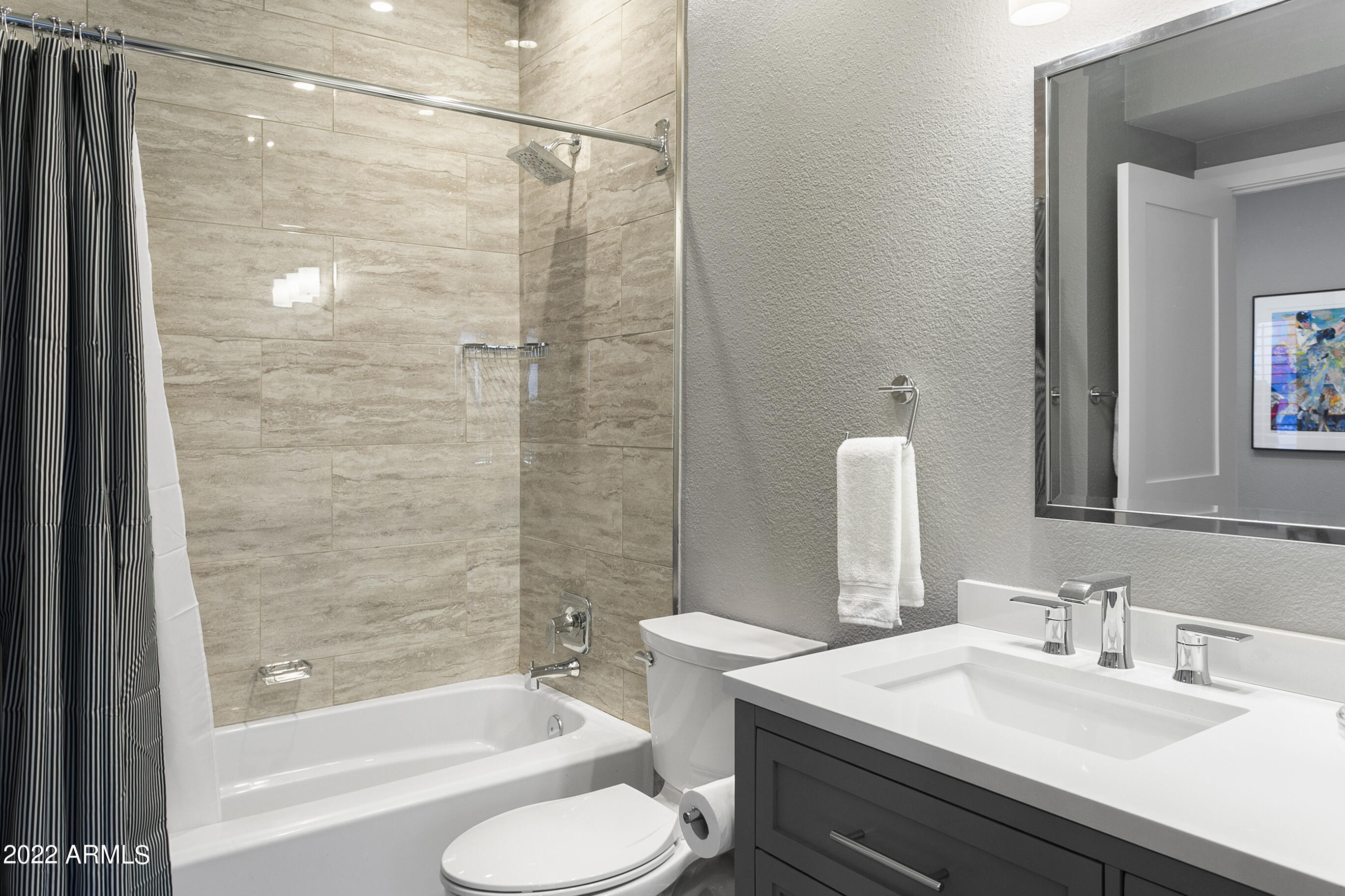 7700 East Gainey Ranch Road, Unit 206 Scottsdale, AZ 85258 - Photo 26 of 33 a bathroom with a sink toilet and shower
