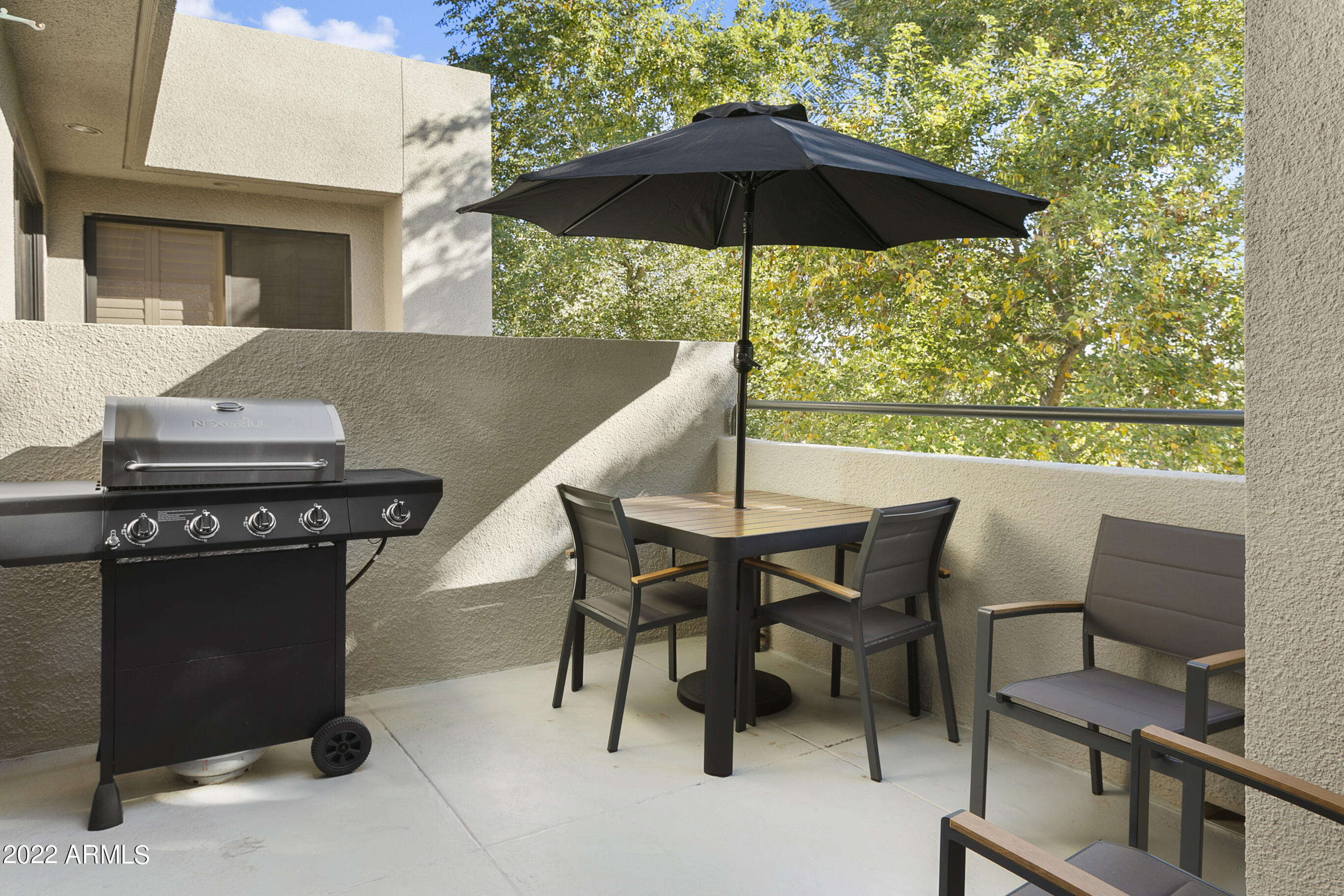 7700 East Gainey Ranch Road, Unit 206 Scottsdale, AZ 85258 - Photo 27 of 33 a view of a patio with furniture and a table