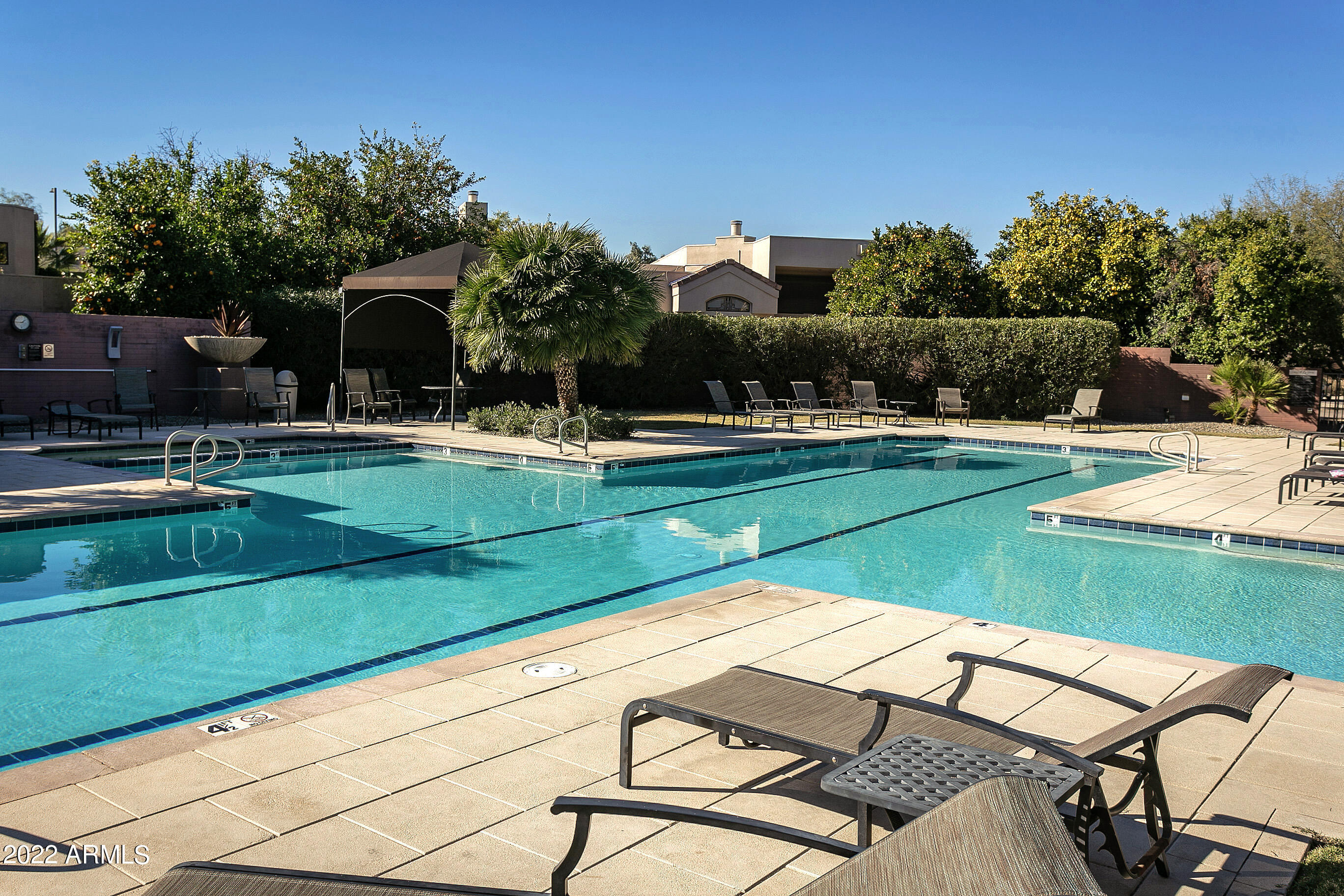 7700 East Gainey Ranch Road, Unit 206 Scottsdale, AZ 85258 - Photo 29 of 33 a view of a patio with chairs and plants