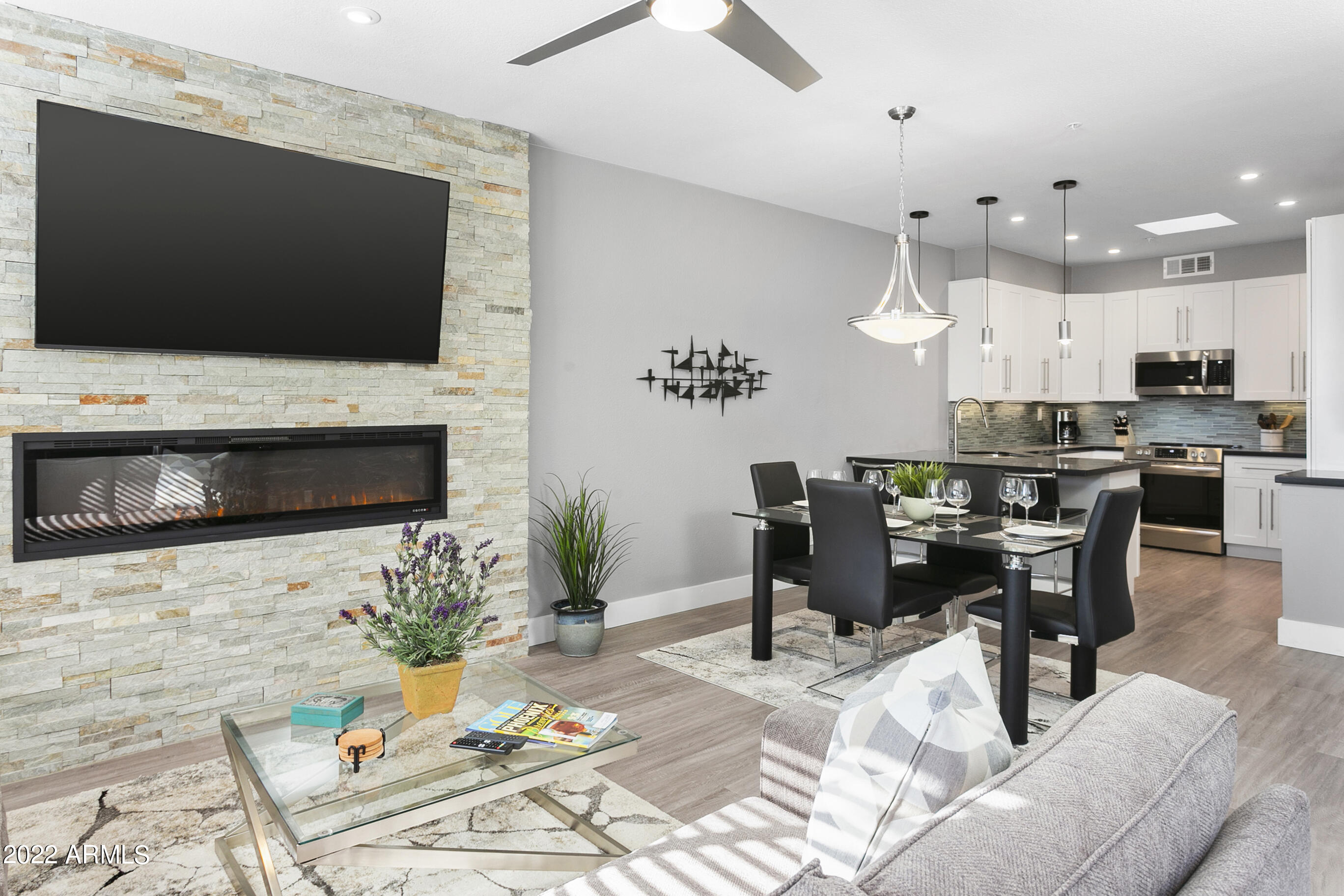 7700 East Gainey Ranch Road, Unit 206 Scottsdale, AZ 85258 - Photo 8 of 33 a living room with furniture and a flat screen tv