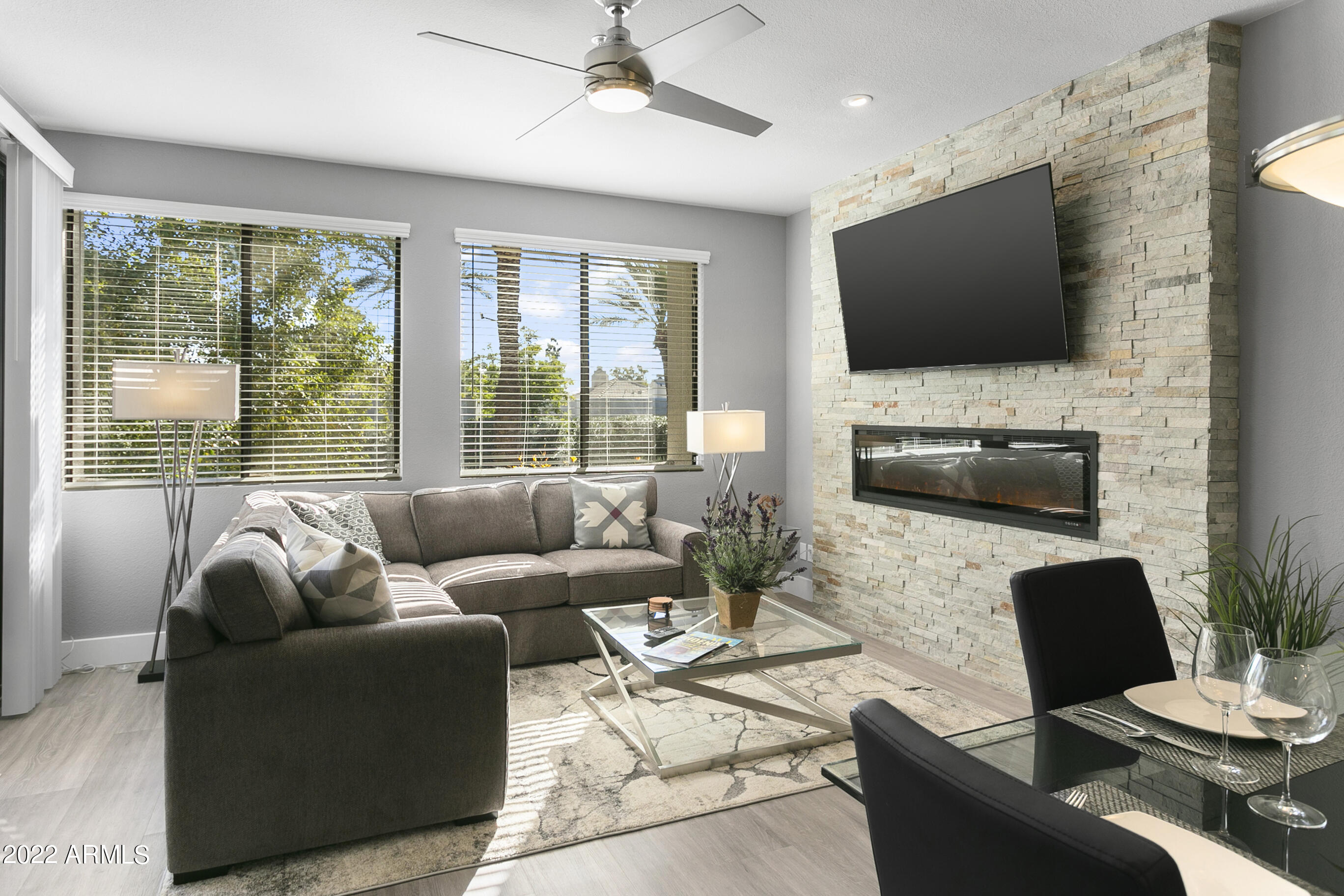 7700 East Gainey Ranch Road, Unit 206 Scottsdale, AZ 85258 - Photo 10 of 33 a living room with furniture and a flat screen tv
