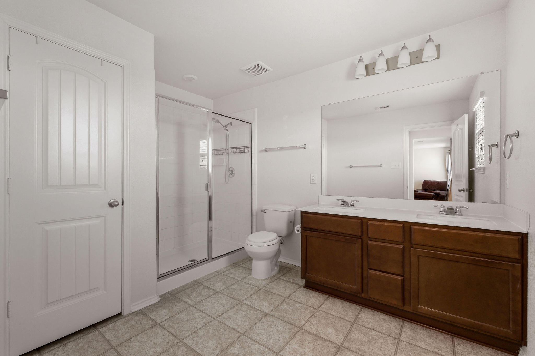 220 Saranac Drive Elgin, TX 78621 - Photo 21 of 32 a spacious bathroom with a double vanity sink a toilet and a mirror