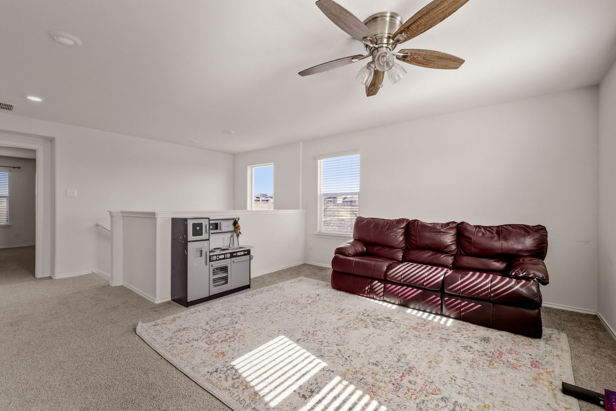 220 Saranac Drive Elgin, TX 78621 - Photo 24 of 32 a living room with furniture and a ceiling fan