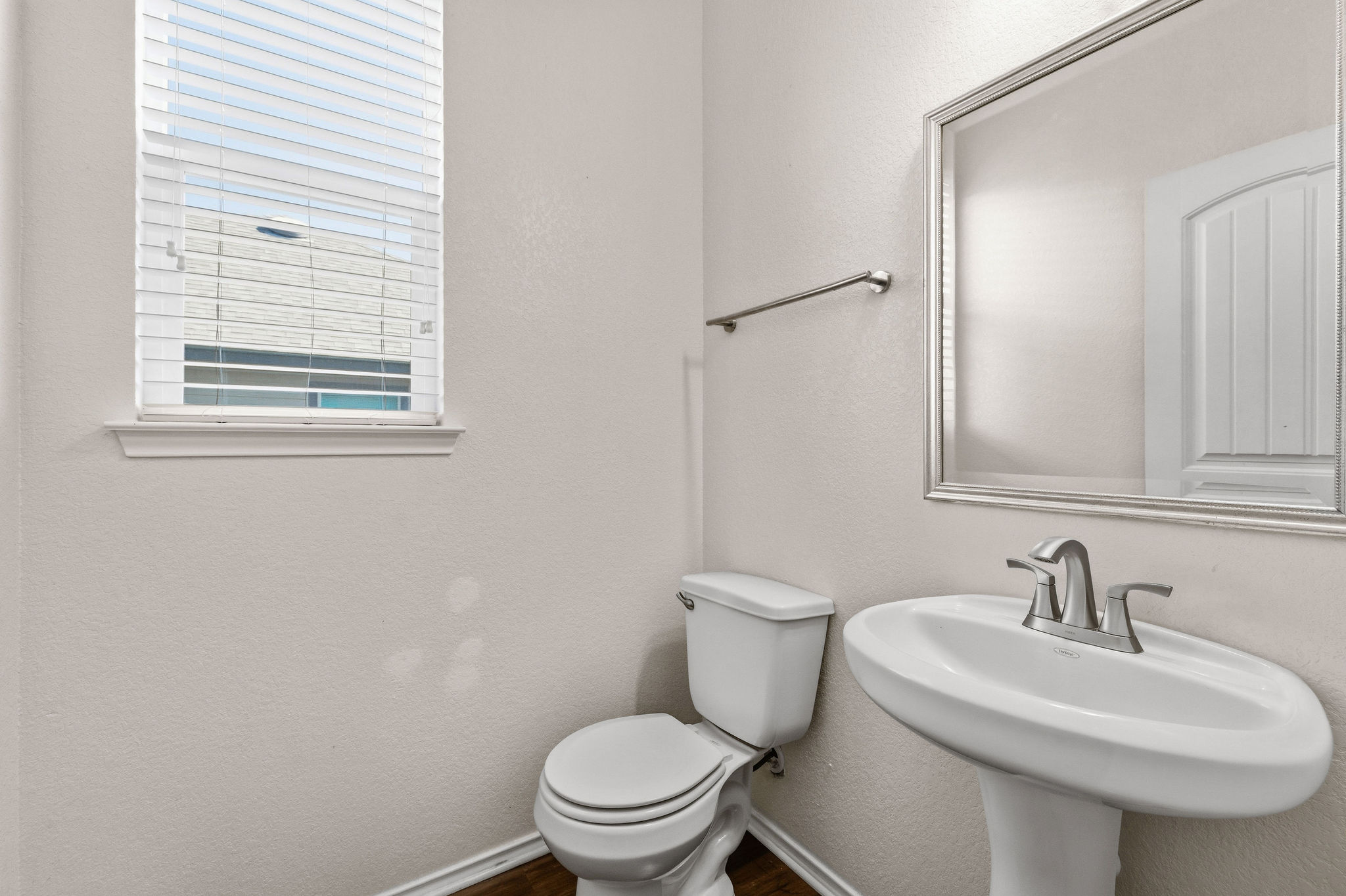 220 Saranac Drive Elgin, TX 78621 - Photo 30 of 32 a white toilet sitting next to a bathroom sink