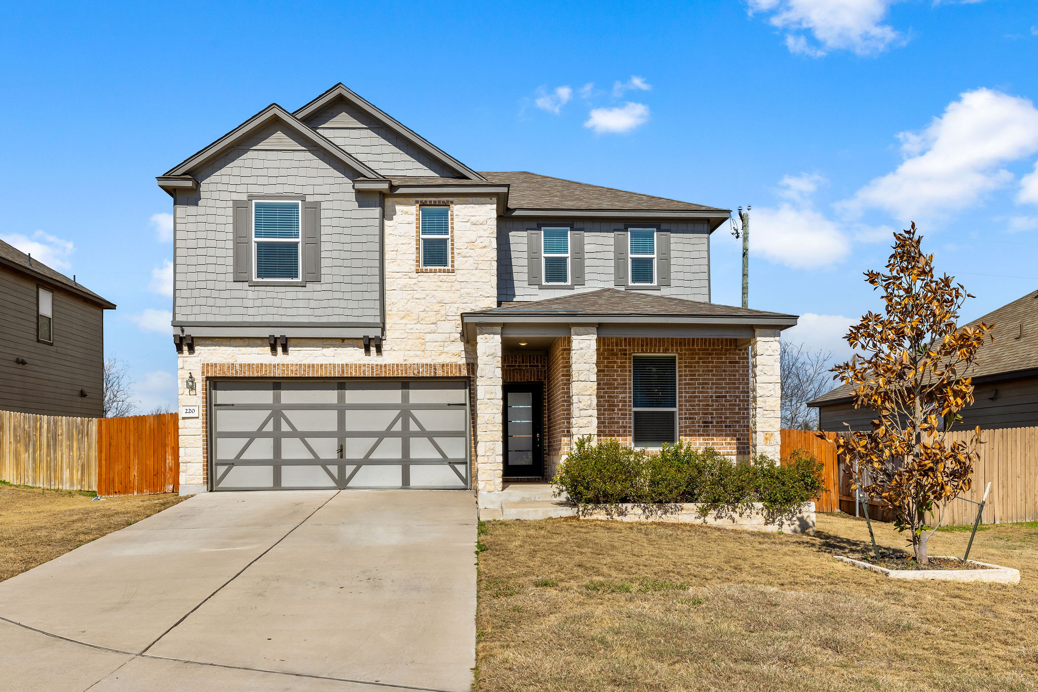 220 Saranac Drive Elgin, TX 78621 - Photo 3 of 32 a front view of a house with a yard and garage