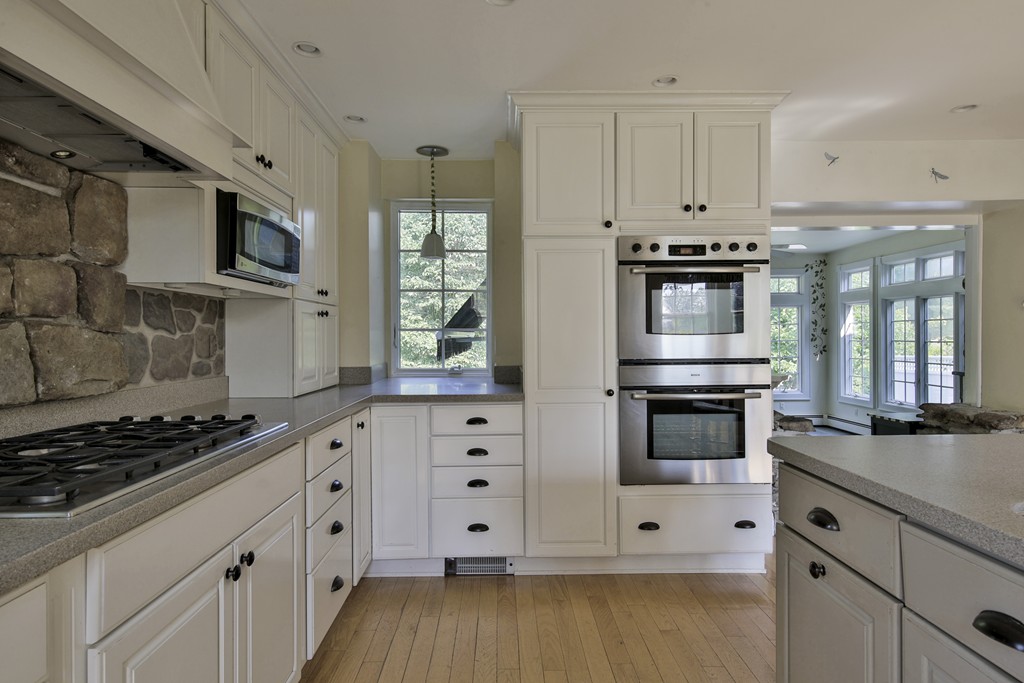 50 Dalton Road Chelmsford, MA 01824 - Photo 11 of 27 a kitchen with stainless steel appliances white cabinets and a stove top oven