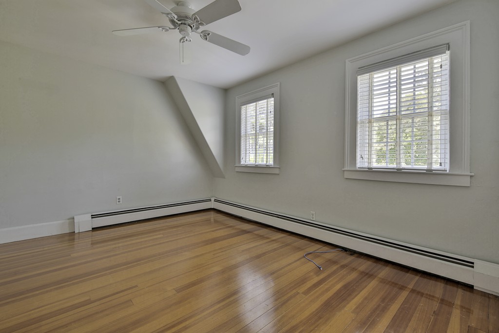 50 Dalton Road Chelmsford, MA 01824 - Photo 25 of 27 an empty room with wooden floor fan and windows