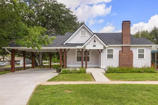 a front view of a house with a yard and porch