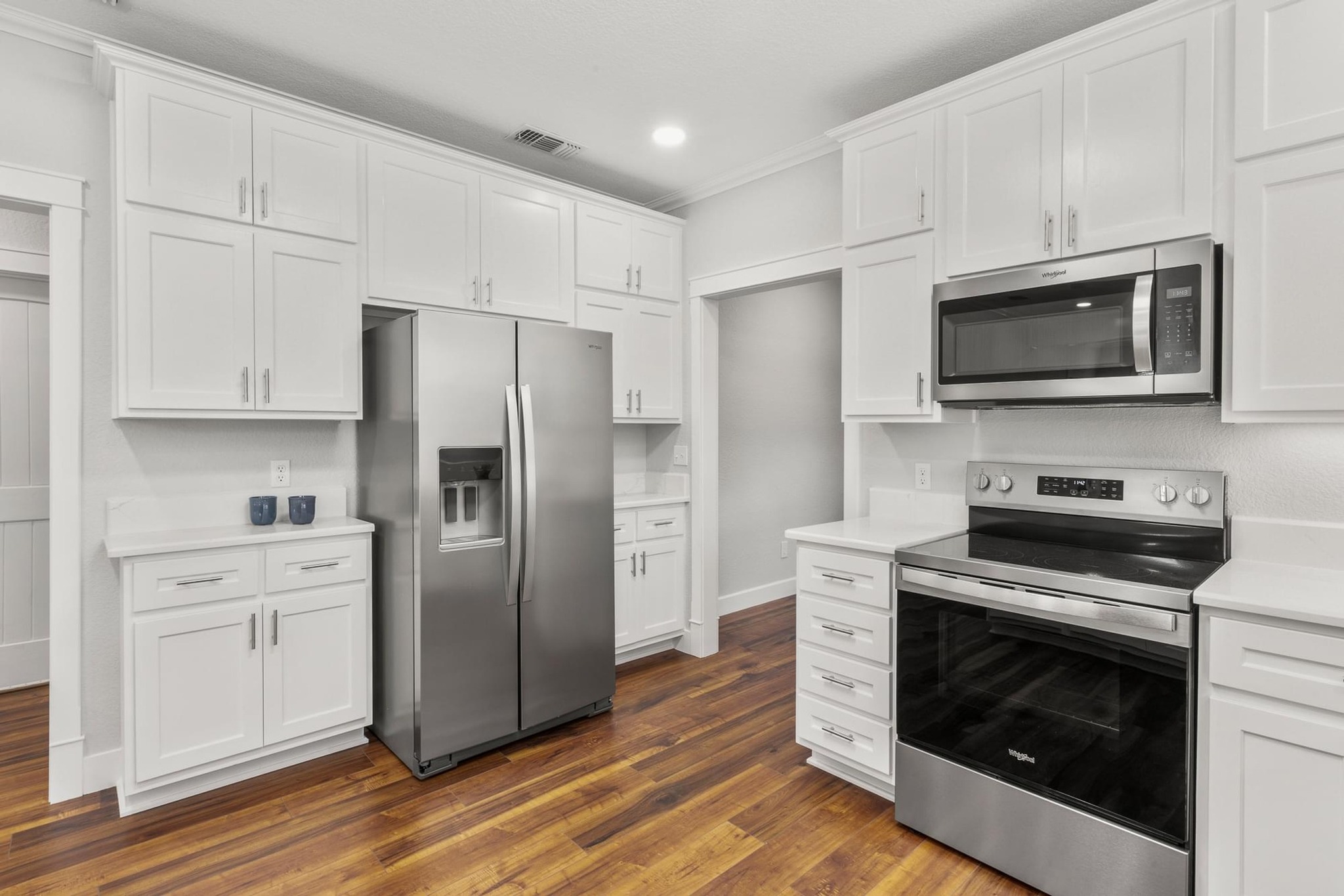522 South Walnut Avenue Luling, TX 78648 - Photo 14 of 33 a kitchen with stainless steel appliances a stove microwave and refrigerator