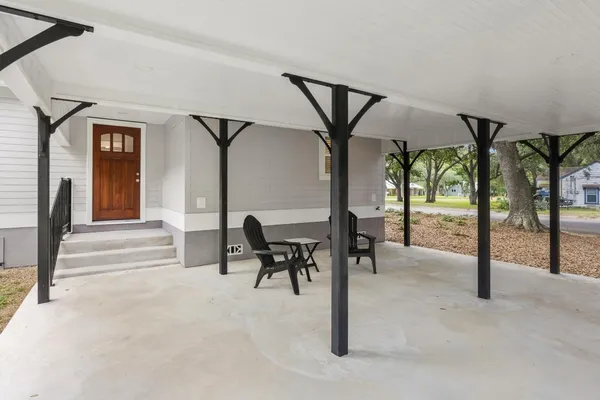 a view of a house with a yard patio and fire pit