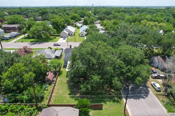 an aerial view of residential house with outdoor space and trees all around