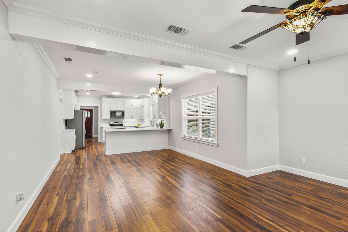 522 South Walnut Avenue Luling, TX 78648 - Photo 7 of 33 a view of a kitchen with wooden floor and a window