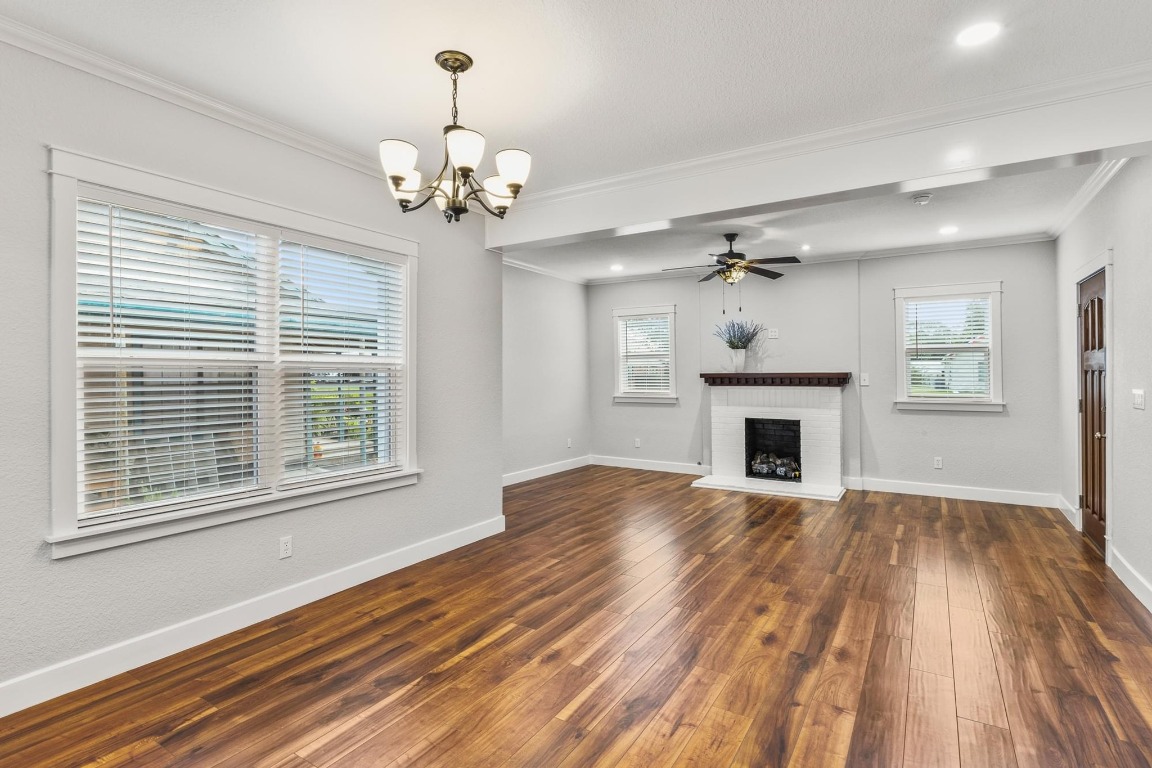 522 South Walnut Avenue Luling, TX 78648 - Photo 10 of 33 a view of a livingroom with a fireplace chandelier and wooden floor