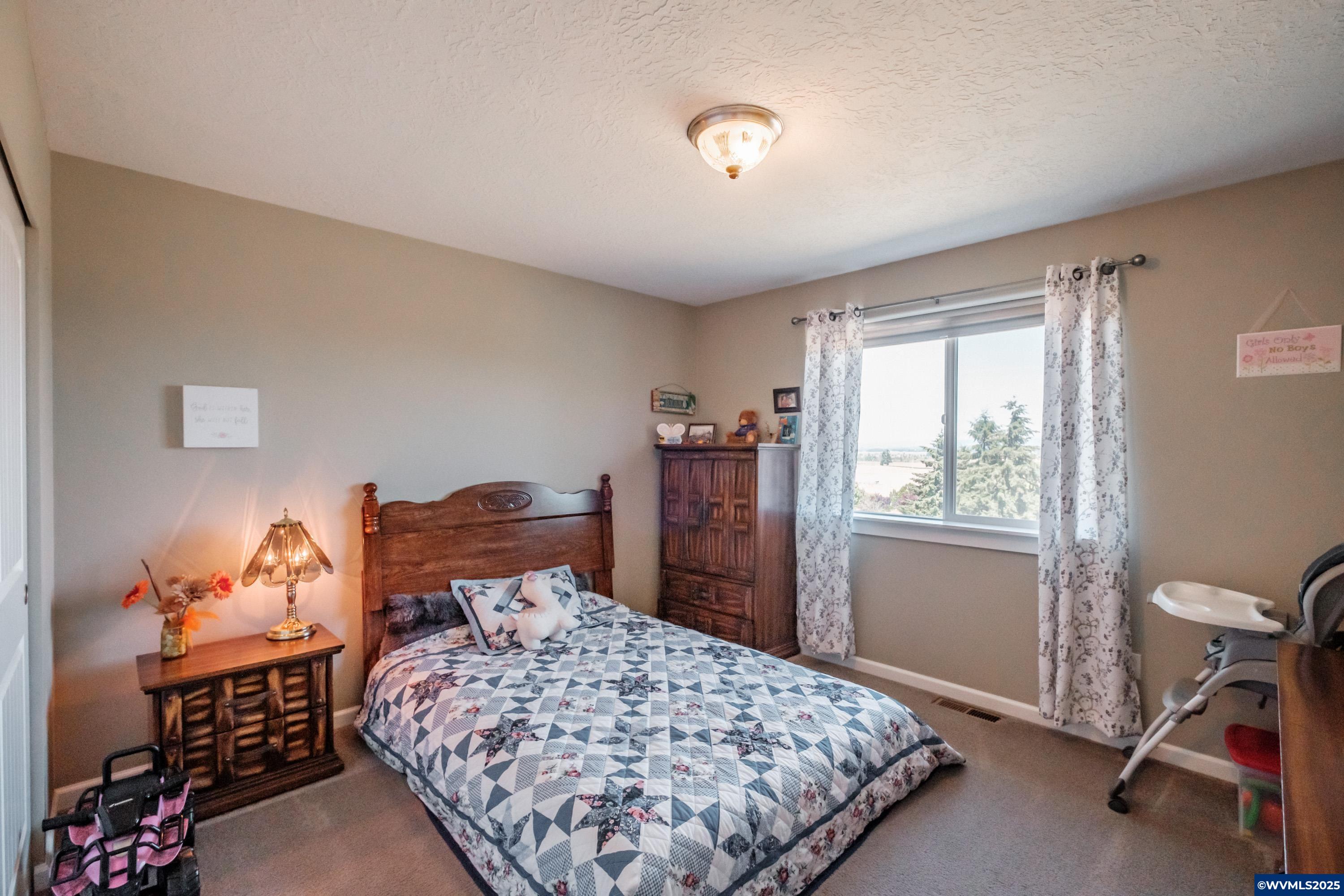 12433 Summit Loop Road Southeast Turner, OR 97392 - Photo 26 of 41 a bedroom with a bed and wooden floor