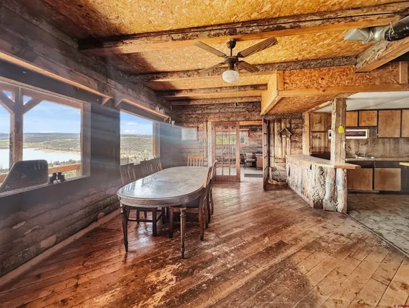 a dining room with a wooden table and chairs