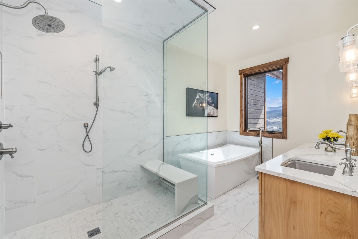 391 Angler Mountain Ranch Road Silverthorne, CO 80498 - Photo 21 of 50 a bathroom with a sink a granite counter and a shower