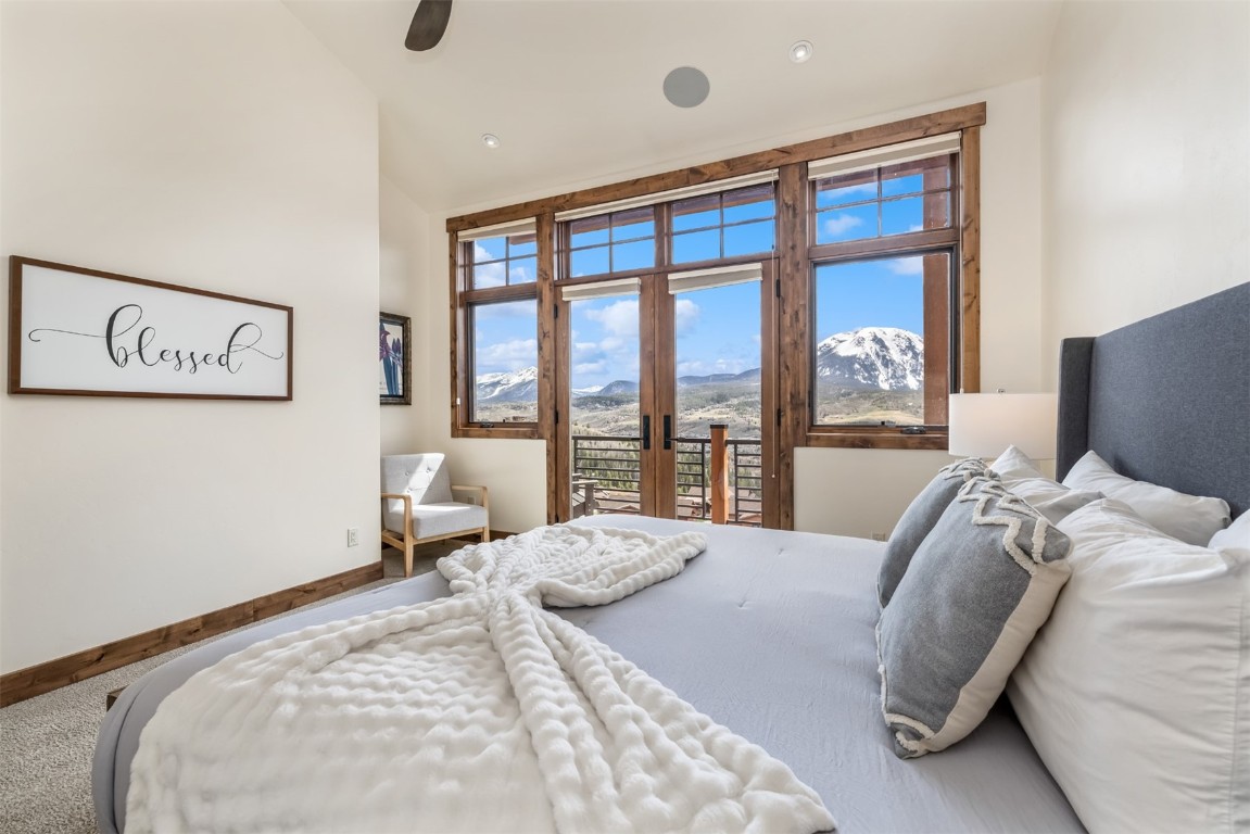 391 Angler Mountain Ranch Road Silverthorne, CO 80498 - Photo 23 of 50 a bedroom with a large bed and a large window