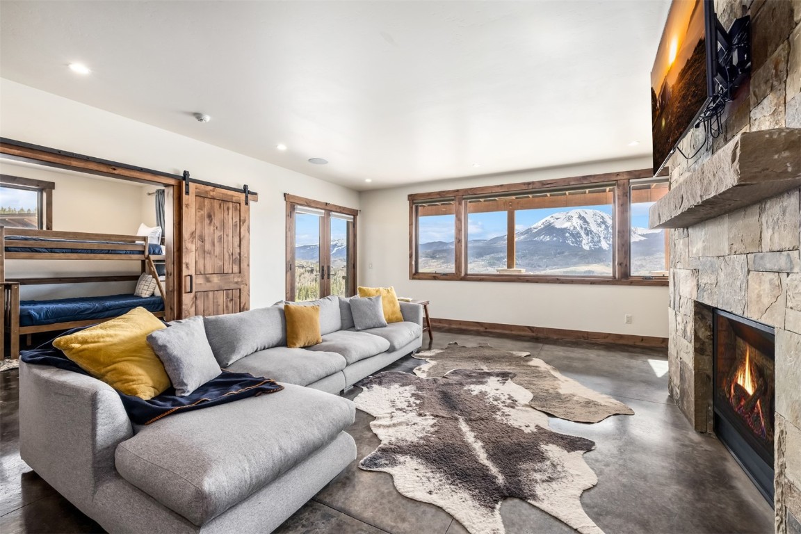 391 Angler Mountain Ranch Road Silverthorne, CO 80498 - Photo 29 of 50 a living room with furniture and a fireplace