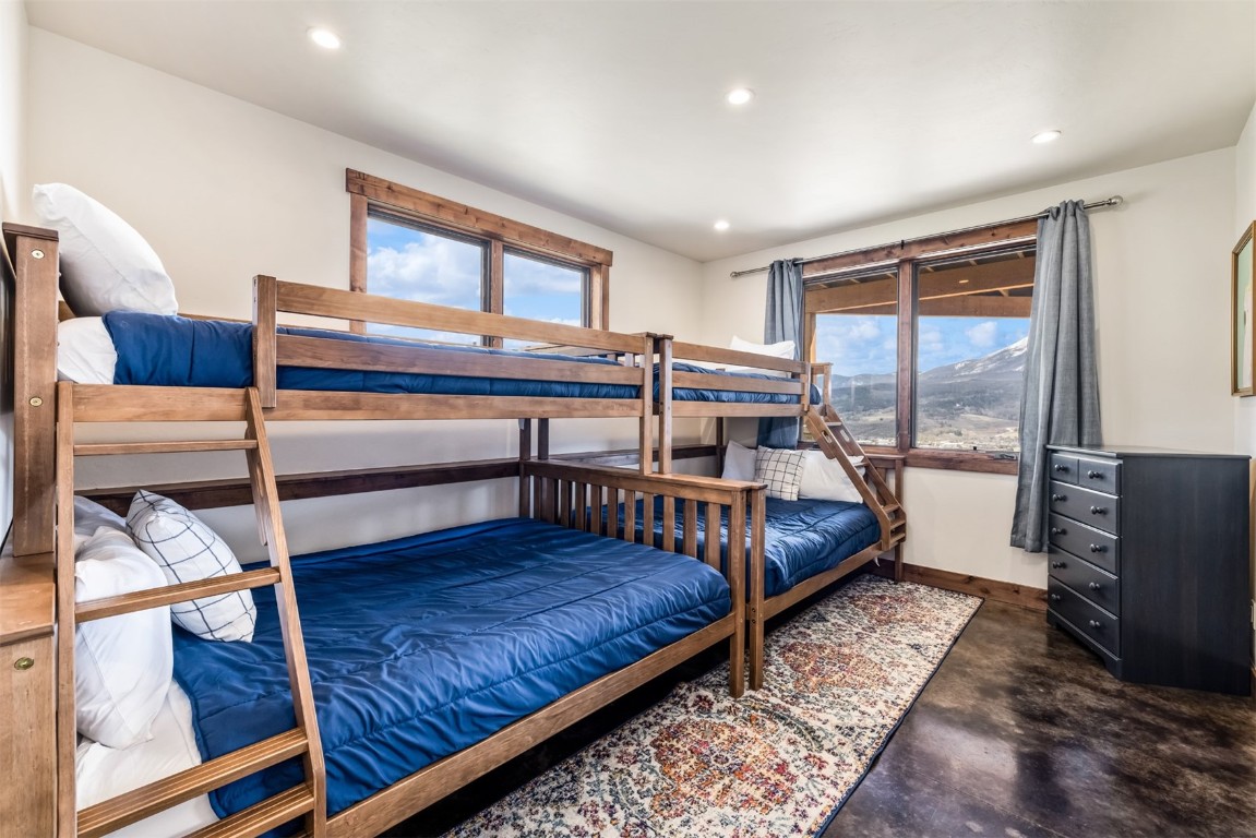 391 Angler Mountain Ranch Road Silverthorne, CO 80498 - Photo 30 of 50 a bedroom with furniture and a wooden floor
