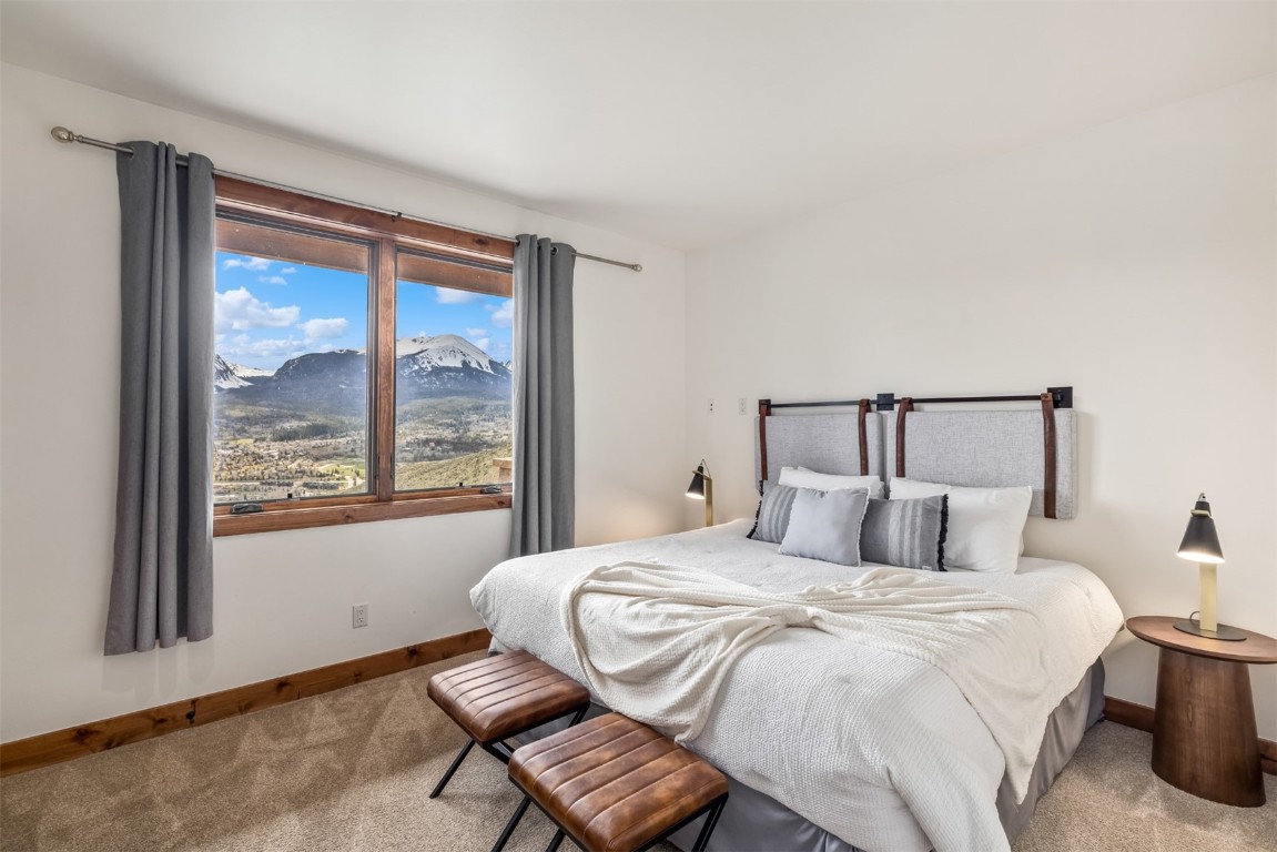 391 Angler Mountain Ranch Road Silverthorne, CO 80498 - Photo 37 of 50 a bedroom with a large bed and a large window