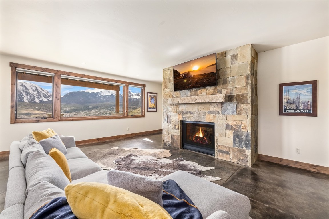 391 Angler Mountain Ranch Road Silverthorne, CO 80498 - Photo 42 of 50 a living room with furniture fireplace and flat screen tv