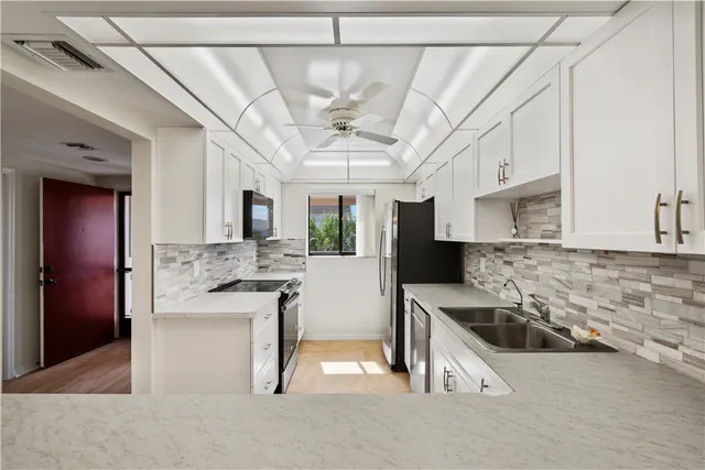 a kitchen with cabinets and stainless steel appliances
