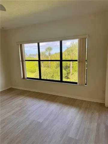 a view of an empty room with a large window