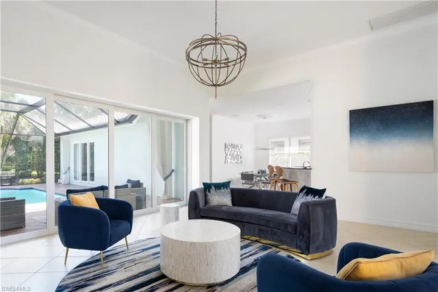a living room with furniture a rug and a chandelier