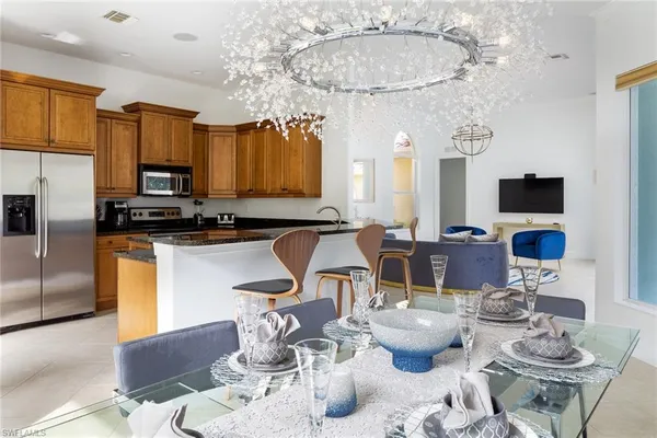 a kitchen with a table chairs stove and kitchen view